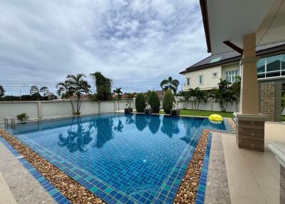 Outdoor swimming pool area with surrounding greenery