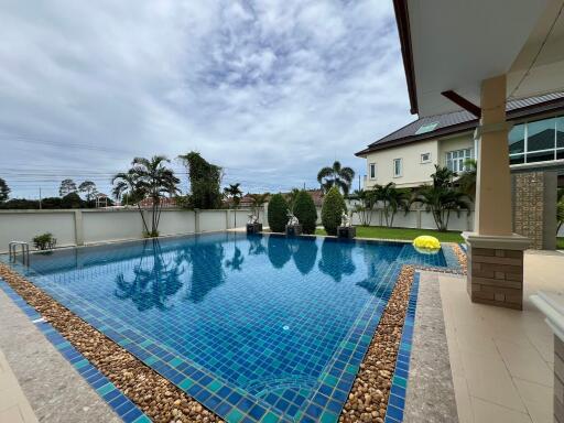 Outdoor swimming pool area with surrounding greenery