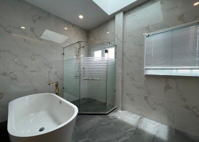 Modern bathroom with bathtub and glass shower enclosure