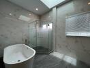 Modern bathroom with bathtub and glass shower enclosure