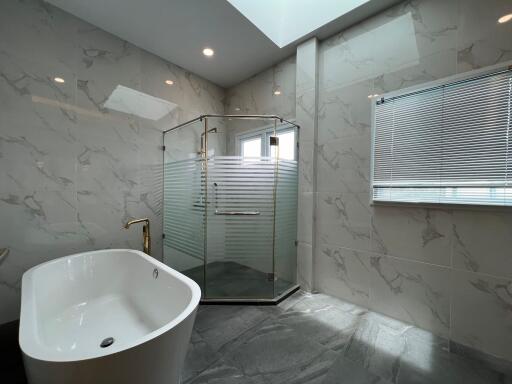 Modern bathroom with bathtub and glass shower enclosure