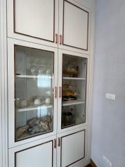 White cabinet with glass doors in kitchen