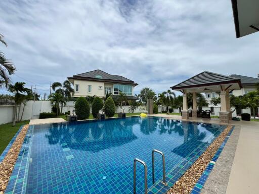 Spacious outdoor pool area with pavilion