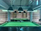 Billiard room with two tables and overhead lights