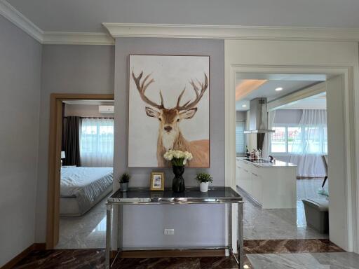 Central view of living area with bedroom and kitchen visible