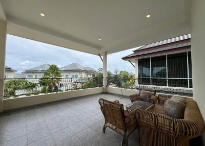 Spacious covered balcony with outdoor furniture and scenic view