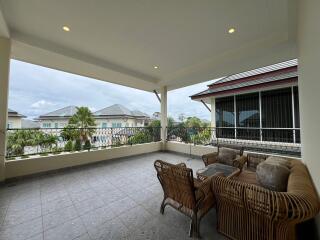 Spacious covered balcony with outdoor furniture and scenic view