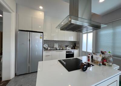 Modern kitchen with island, appliances, and glass door