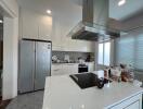 Modern kitchen with island, appliances, and glass door