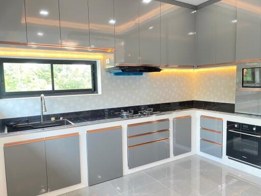 Modern kitchen with grey cabinets and built-in appliances