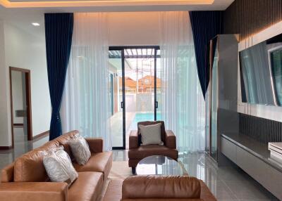 Spacious living room with a view of a swimming pool