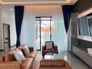 Spacious living room with a view of a swimming pool