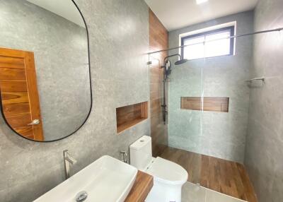 Modern bathroom with walk-in shower and wooden accents