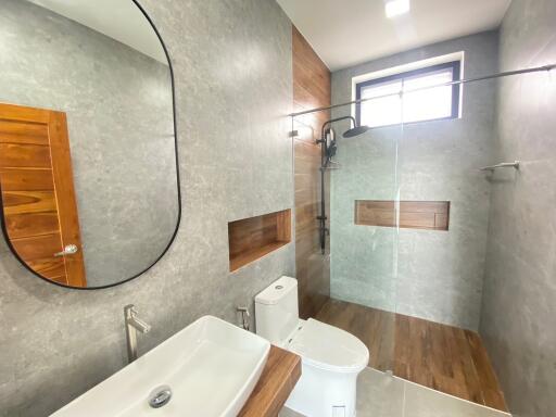 Modern bathroom with walk-in shower and wooden accents