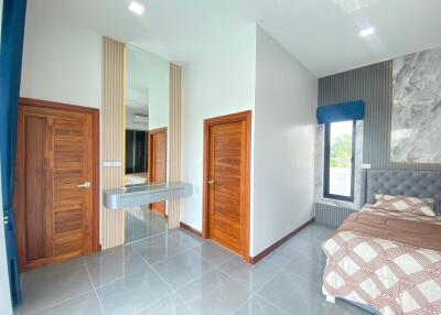 Modern bedroom with wooden doors and a large bed