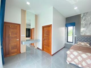 Modern bedroom with wooden doors and a large bed