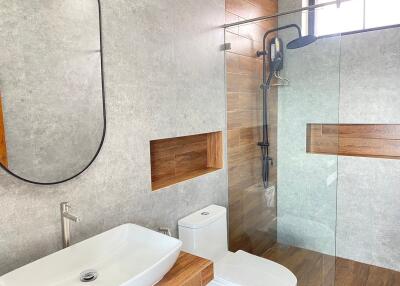 Modern bathroom with a walk-in shower and wooden accents