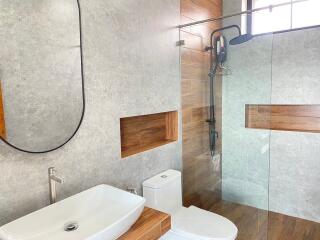 Modern bathroom with a walk-in shower and wooden accents