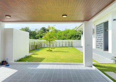 covered patio area looking out to a well-maintained backyard