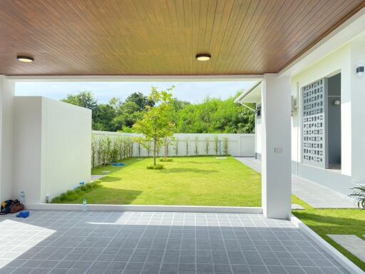 covered patio area looking out to a well-maintained backyard