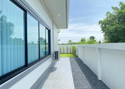 House exterior view with backyard and large glass windows