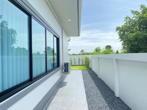 House exterior view with backyard and large glass windows