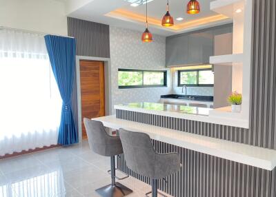 Modern kitchen with breakfast bar and stylish lighting