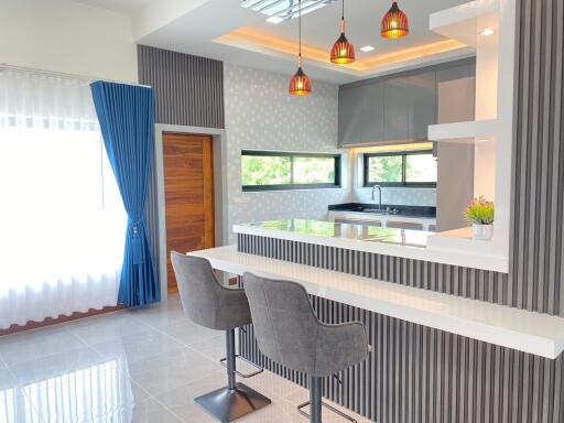 Modern kitchen with breakfast bar and stylish lighting