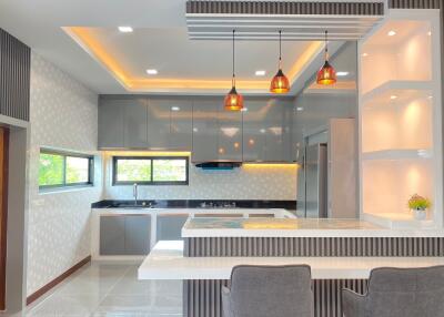 Modern kitchen with hanging lights and breakfast bar