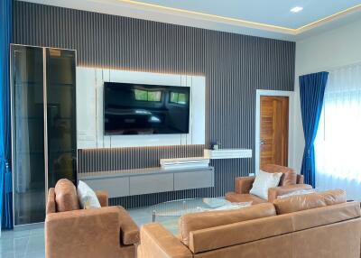 Modern living room with brown sofas and wall-mounted TV