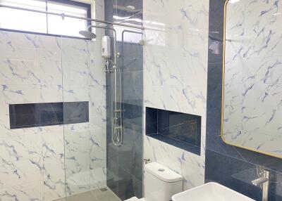 Modern bathroom with marble tile walls and shower