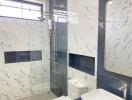 Modern bathroom with marble tile walls and shower