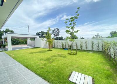 Beautifully landscaped garden with green lawn and trees