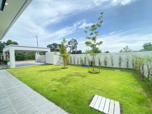 Beautifully landscaped garden with green lawn and trees