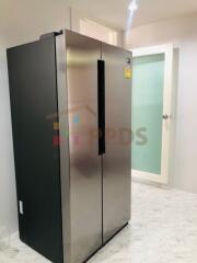 Modern kitchen with stainless steel refrigerator