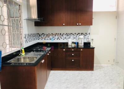 Modern kitchen with wooden cabinets and tiled backsplash