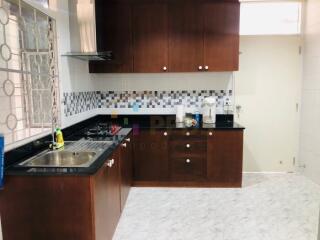 Modern kitchen with wooden cabinets and tiled backsplash