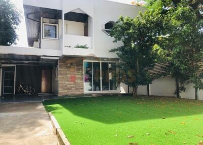 Exterior view of a modern house with a green lawn