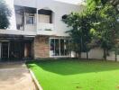 Exterior view of a modern house with a green lawn