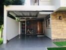 Covered garage area with a bicycle and a secure entrance door