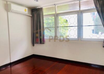 Bedroom with large windows and air conditioning unit