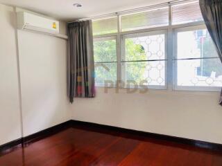 Bedroom with large windows and air conditioning unit