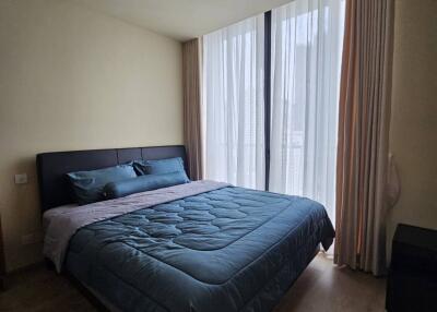 Bedroom with large window and bed