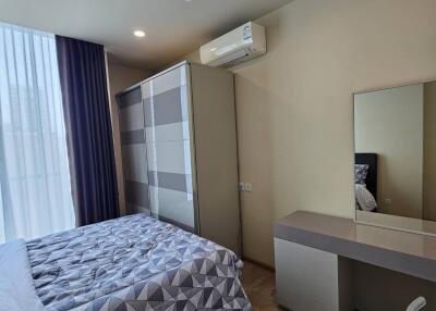 Modern bedroom with a large wardrobe and vanity desk