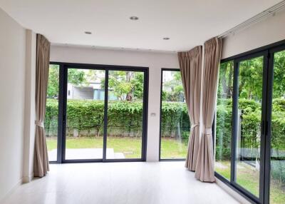 Spacious living room with large windows and garden view