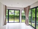 Spacious living room with large windows and garden view