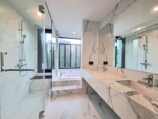 Modern bathroom with marble finishes and glass shower enclosure