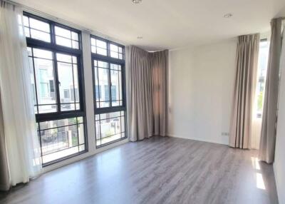 Bright living room with large windows and wood flooring