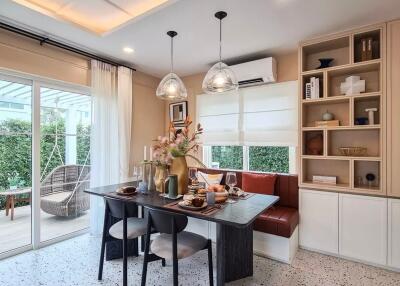 A modern dining room with a table set for a meal, built-in storage, and a view of a patio