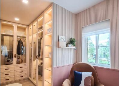 Cozy bedroom with walk-in closet and armchair